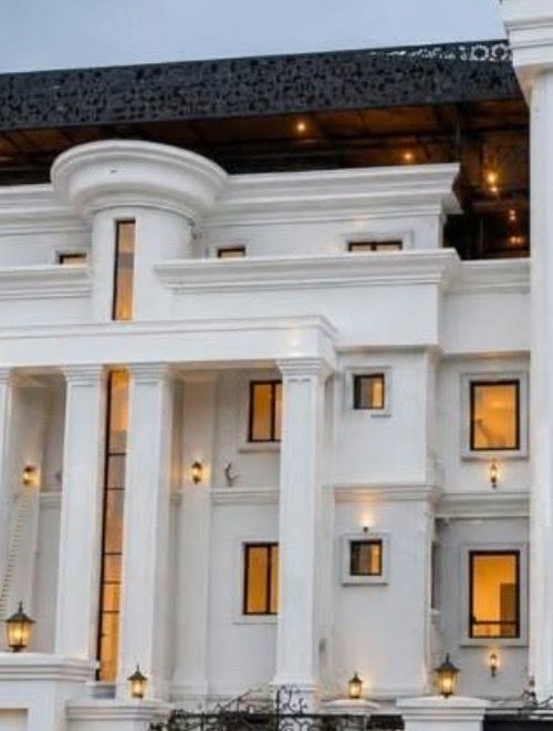 The building’s columned facade with warm-lit windows